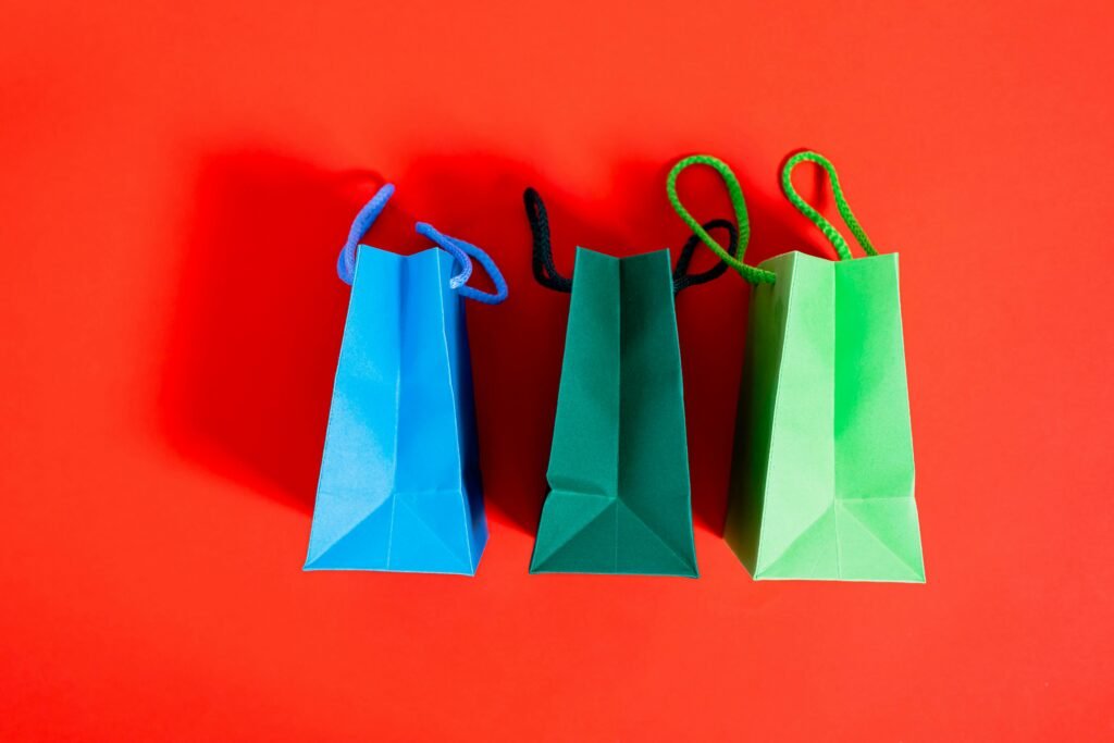 Shopping Bags On A Red Surface representing eco-friendly brands, climate-friendly brands