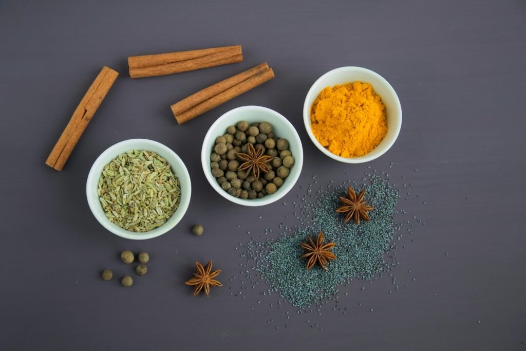Assorted Spices Near White Ceramic Bowls to show spice production in India