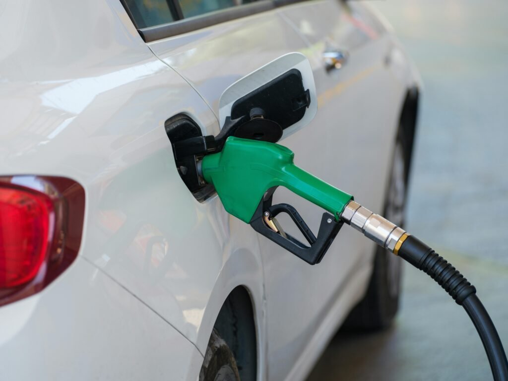 Gas Pump Nozzle Filling the White Car, biofuels