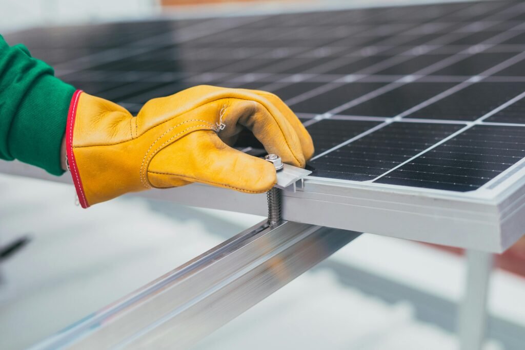 Person's Hand on Solar Panel, decentralized energy systems