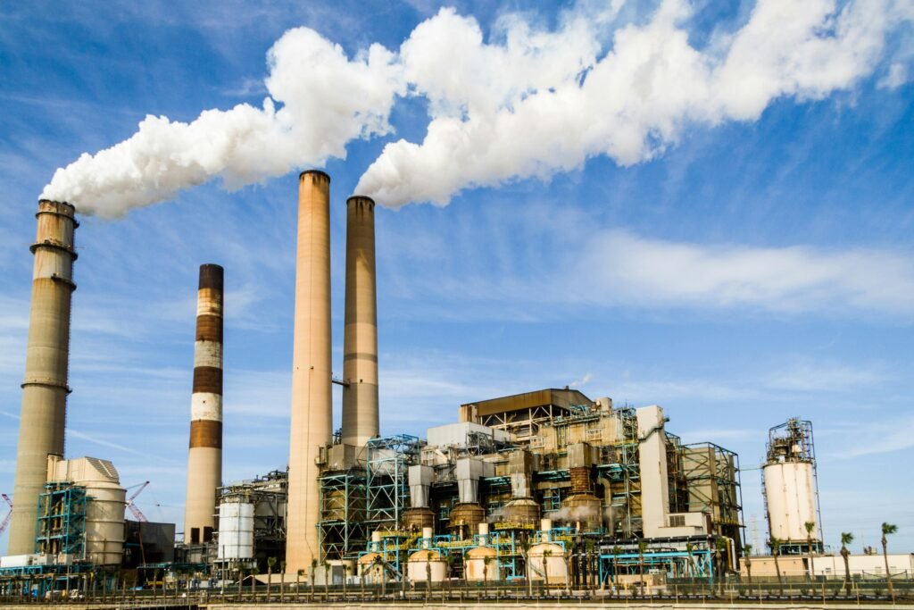 Photo Of an Industrial Factory Emitting Smoke showing the need for air quality improvement.