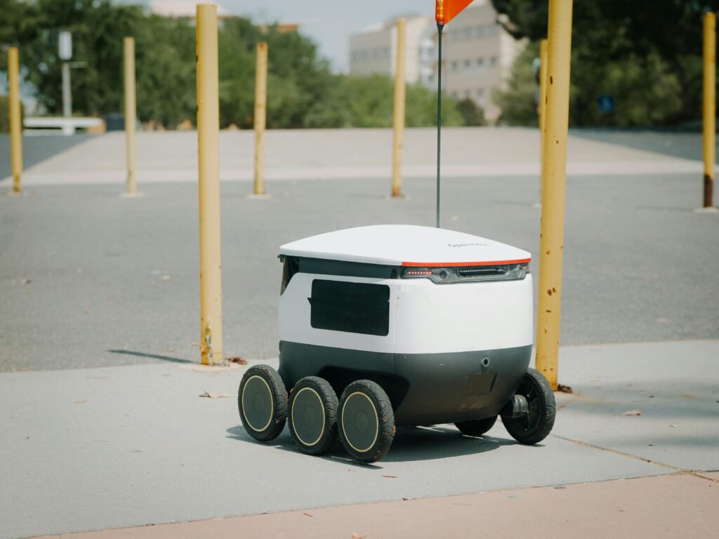 Delivery Robot Beside Yellow Protection, Barricade autonomous vehicles