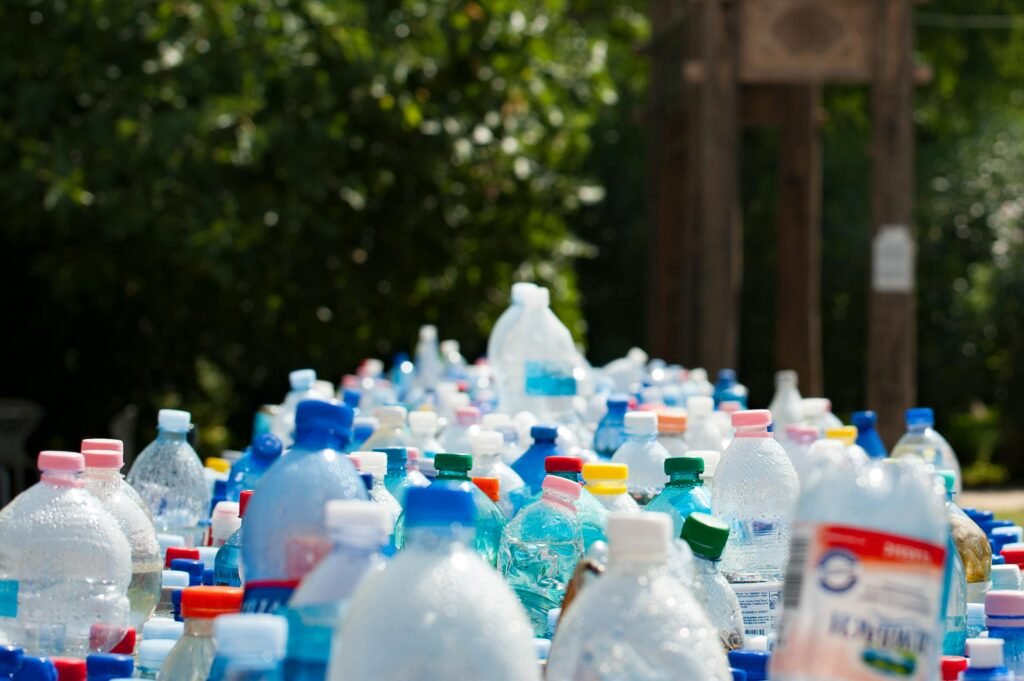 A vibrant collection of plastic bottles in an outdoor recycling setup, showcasing environmental awareness. Plastic waste management
