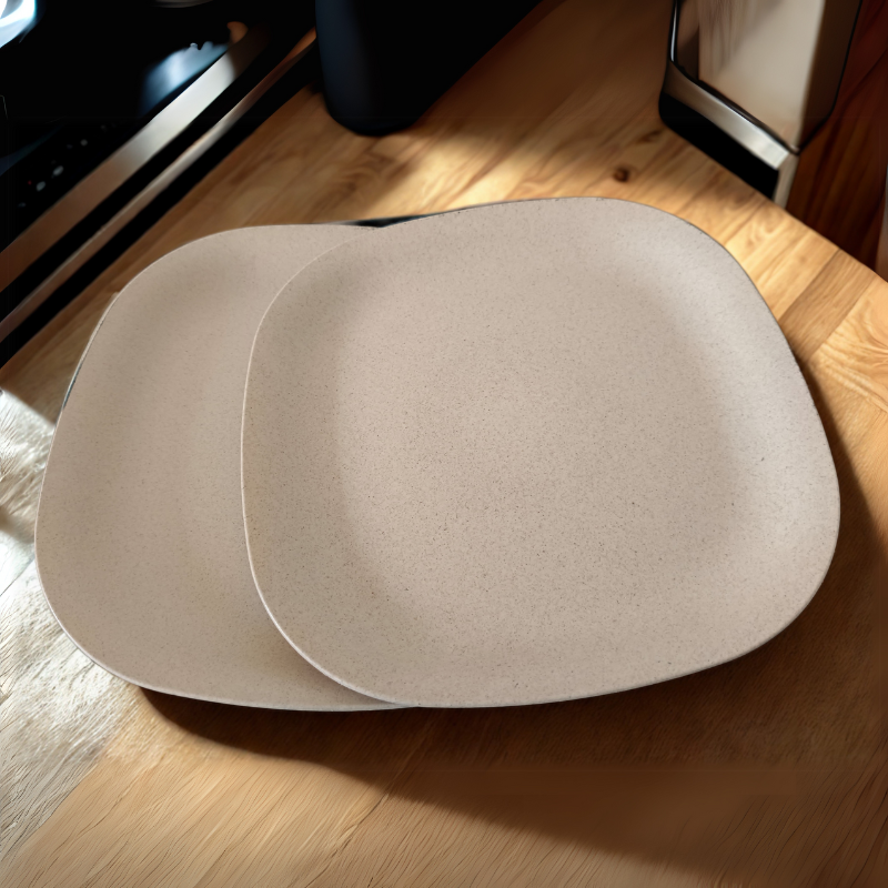 2 softbeige plates kept on wooden table
