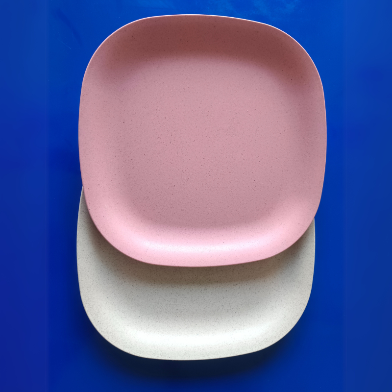 1 pink and 1 soft beige plate kept on blue table